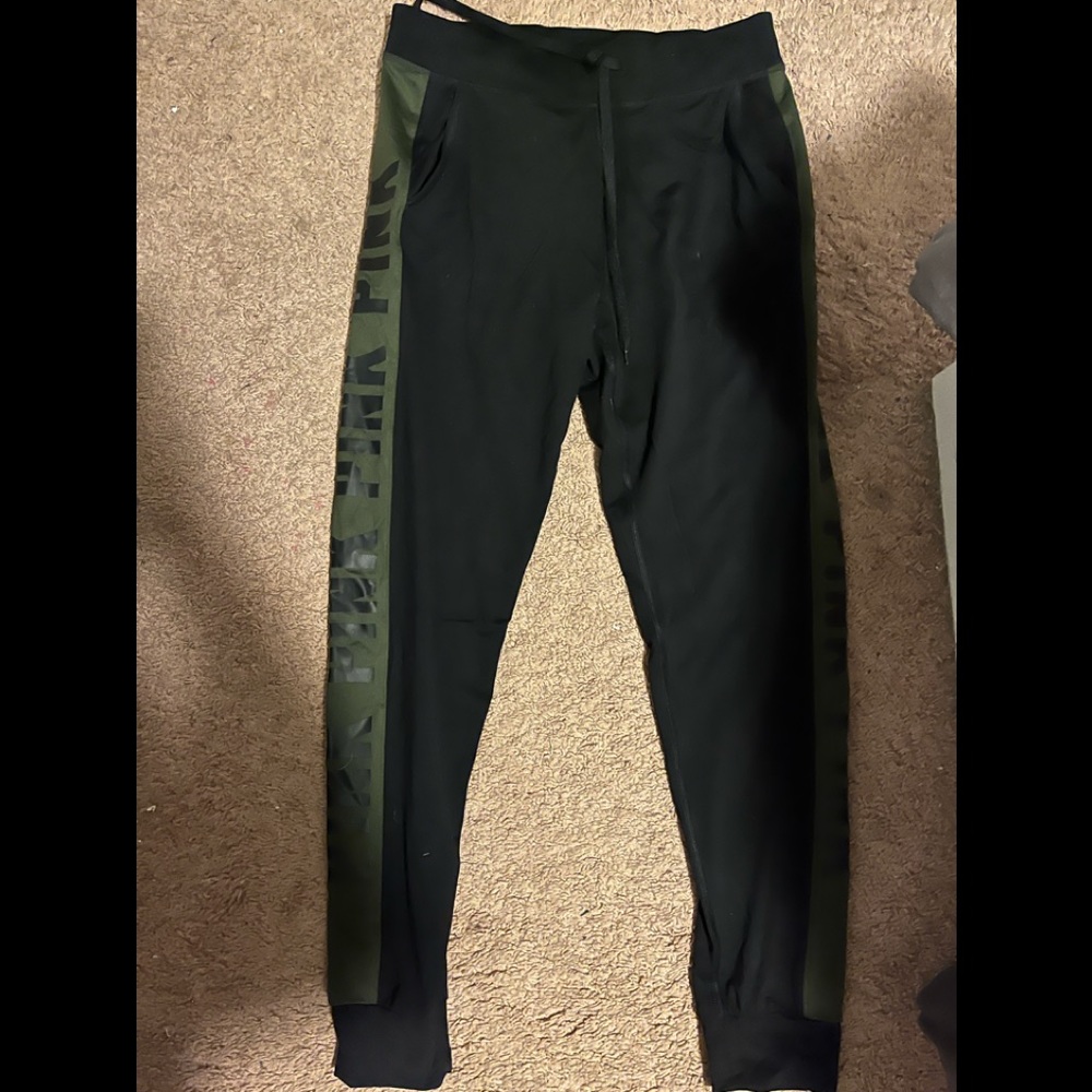 sweats from pink, black with dark green on the side of them